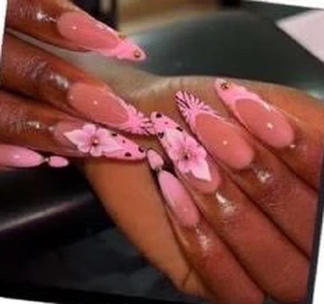 Long pink almond nails with 3D flower art and dotted French tips